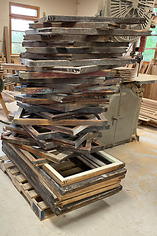 Pallet full of window sashes waiting for restoration.